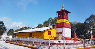 A yellow and red building with a clock tower