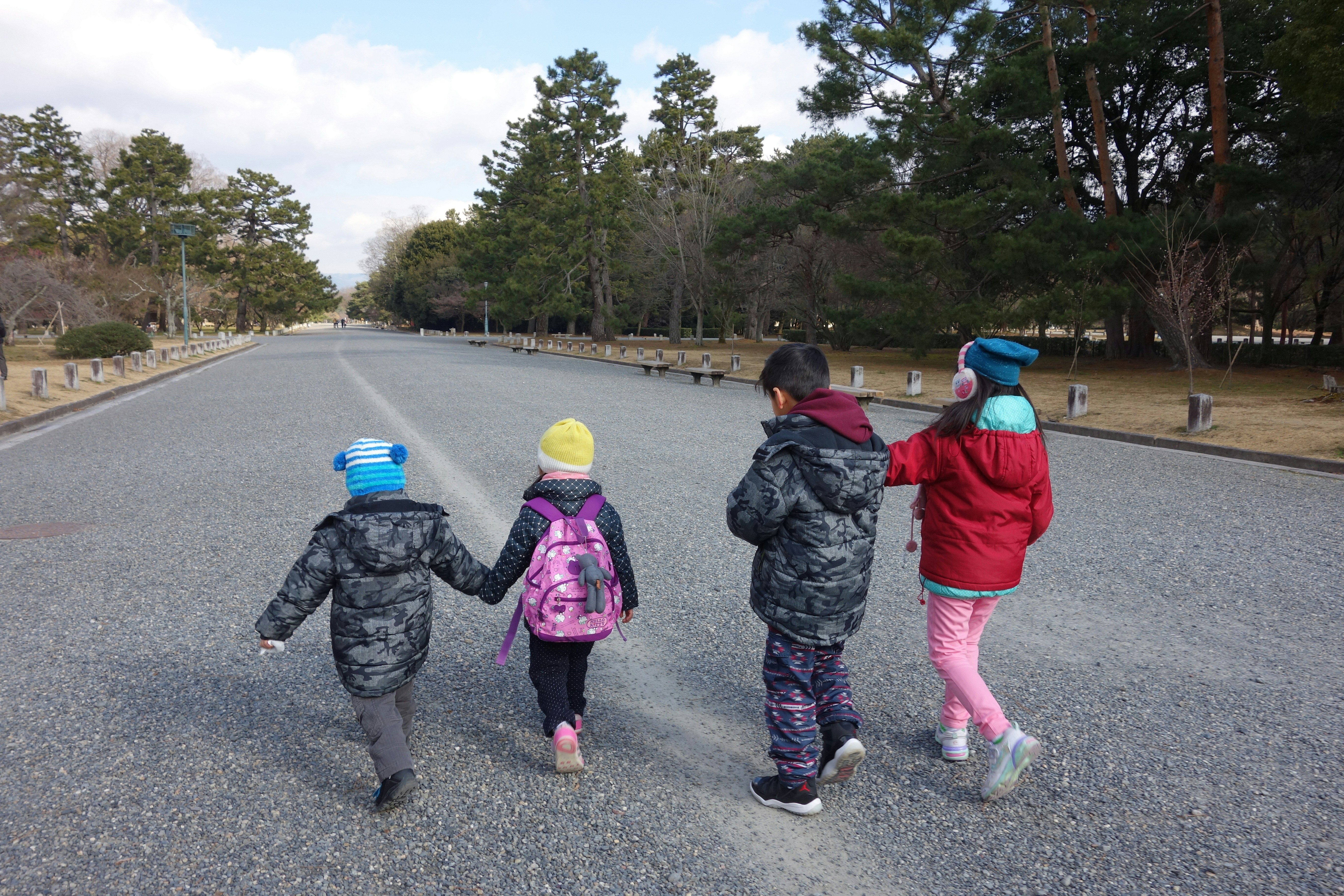 A group of children walking down a road