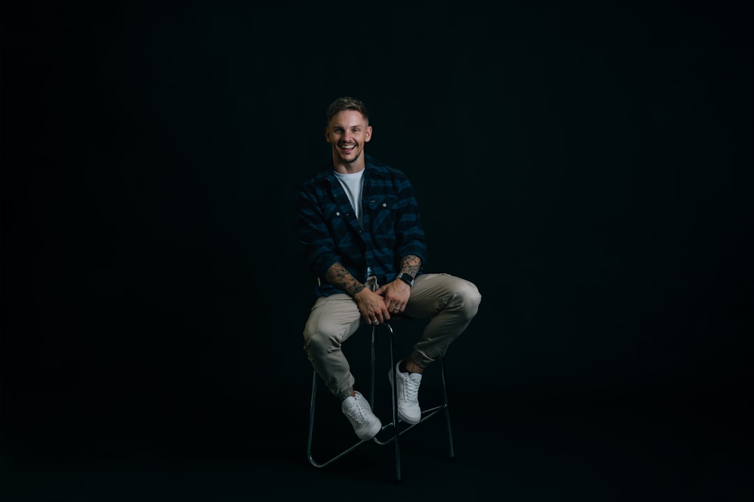 A man sitting on a chair in the dark,
