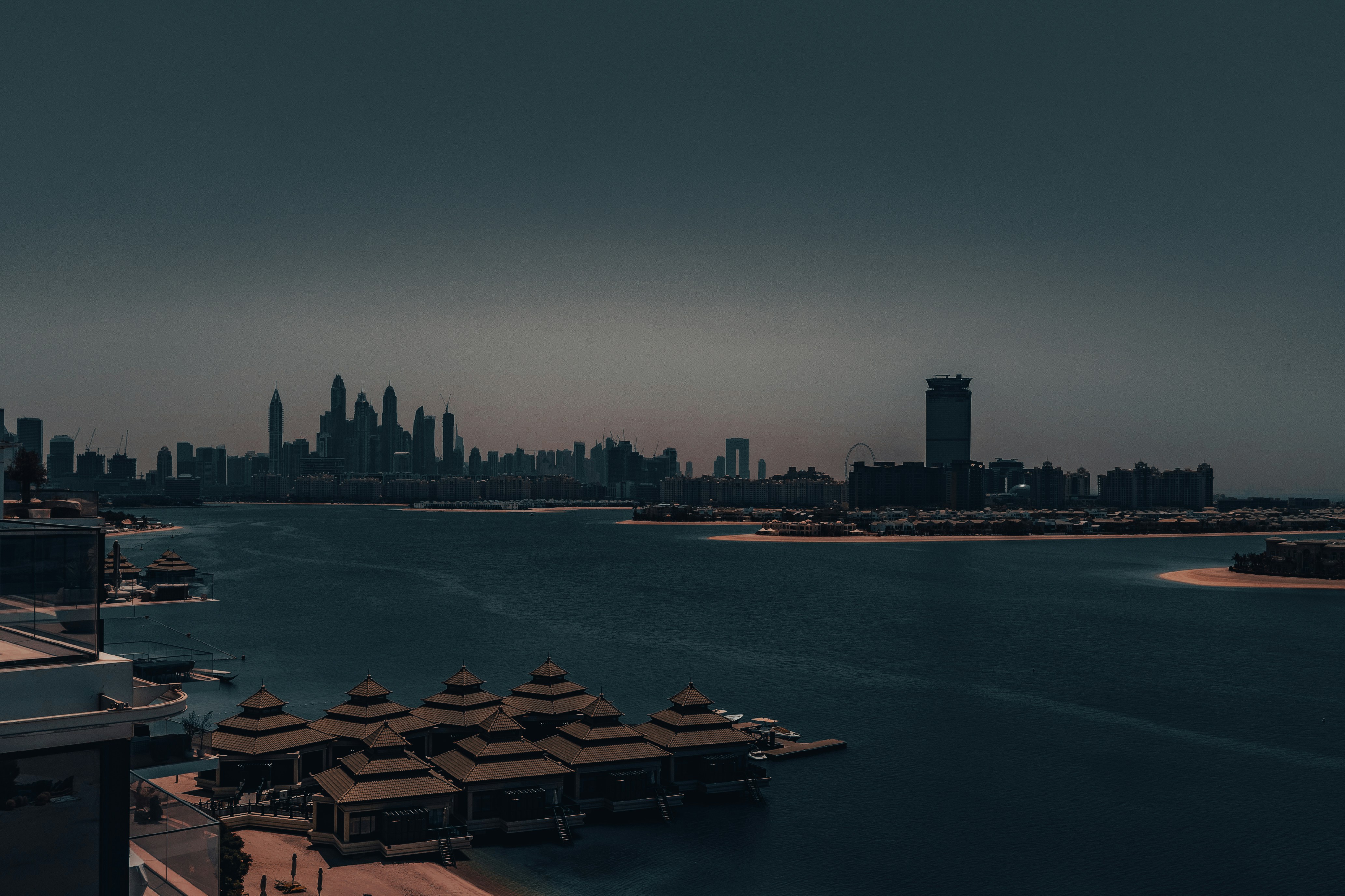 Dubai city skyline at night with water in foreground