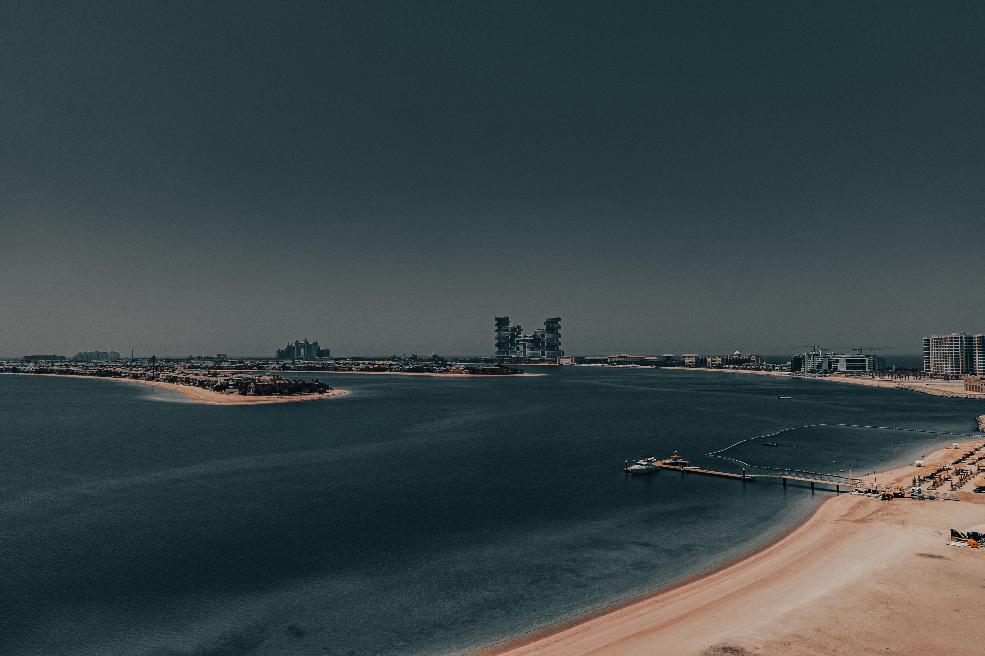 Vista aérea de uma praia com uma cidade ao fundo