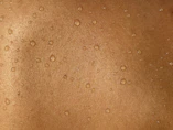 A man's back with water drops on it