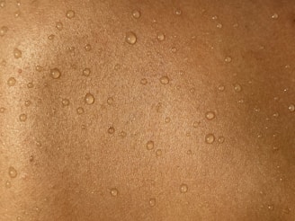 A man's back with water drops on it