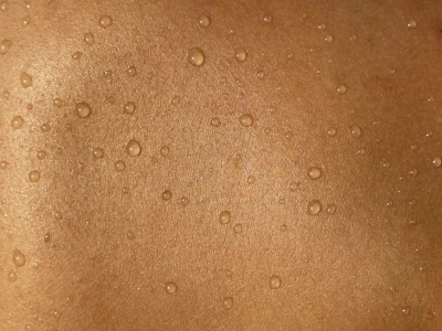 A man's back with water drops on it