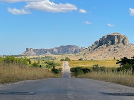An empty road with a mountain in the background