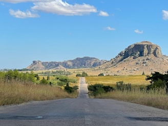 An empty road with a mountain in the background