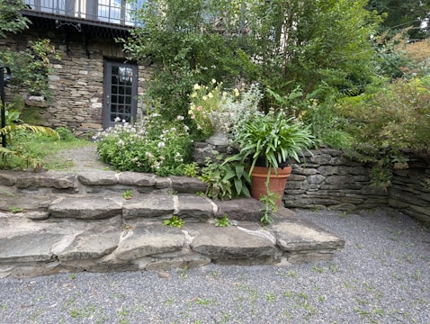A stone house with a large garden in front of it