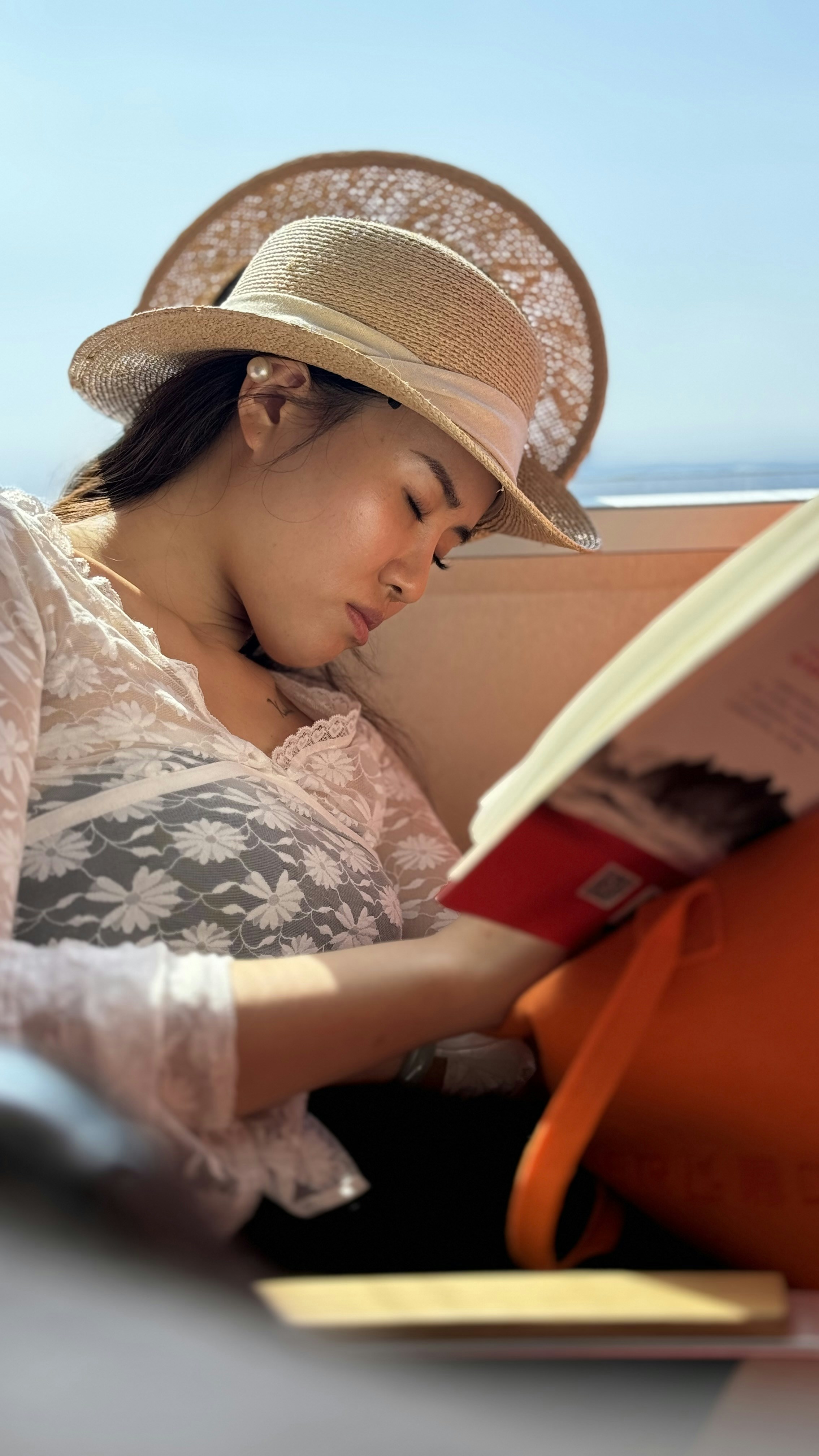 A woman in a hat reading a book
