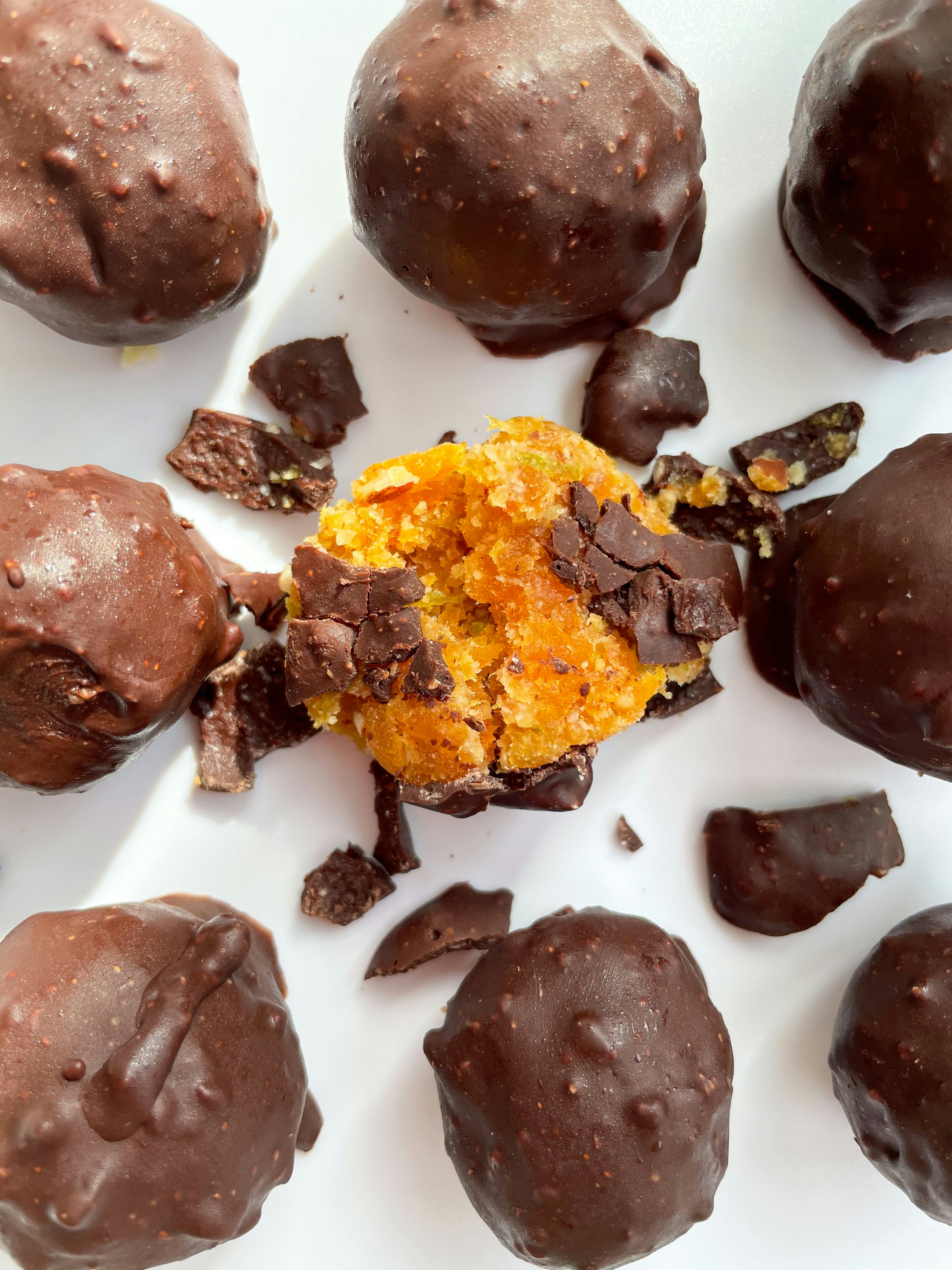 A white plate topped with chocolate covered balls