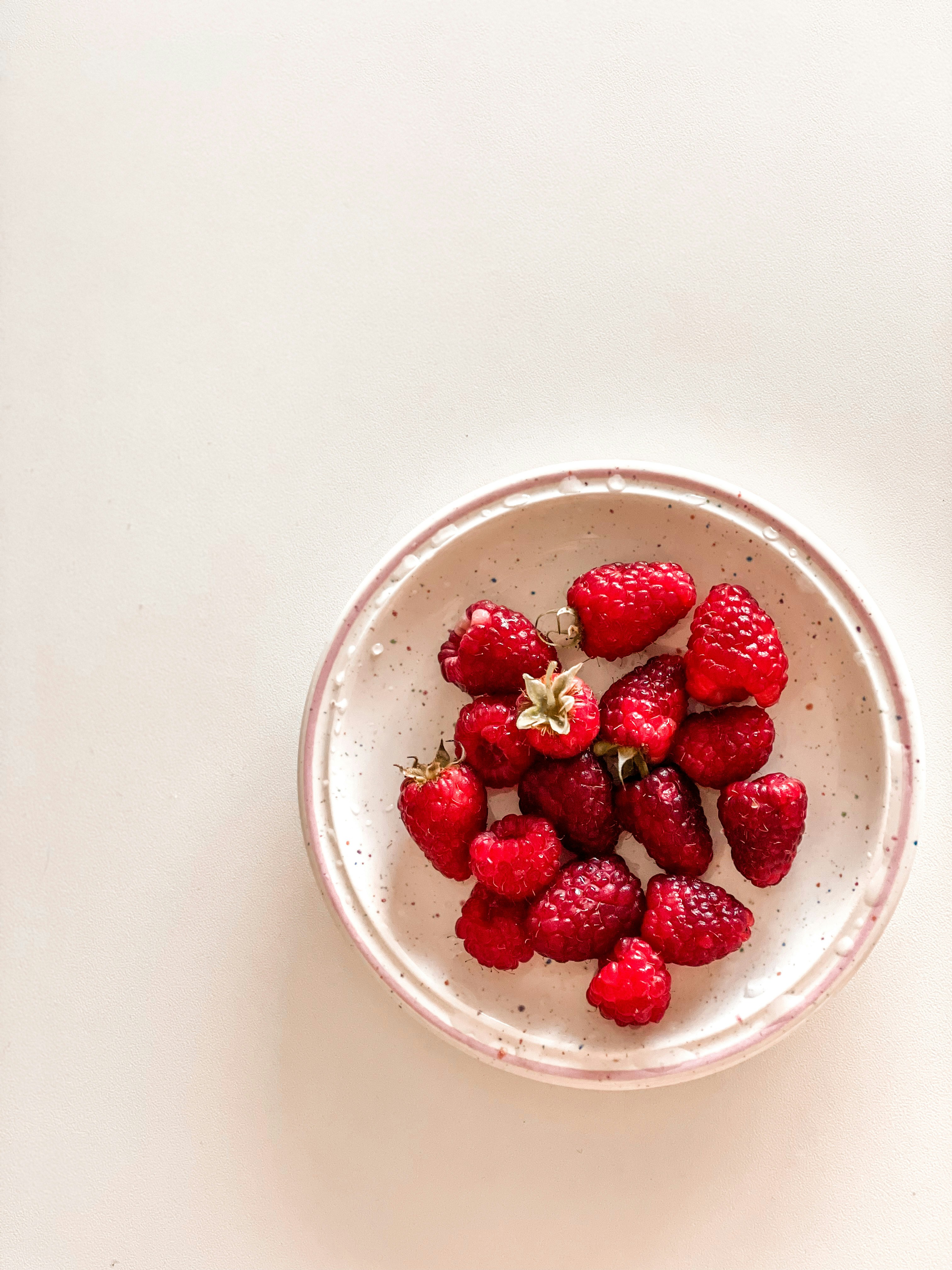 A bowl of strawberries on a white table