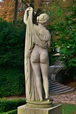 A statue of a woman holding a tree