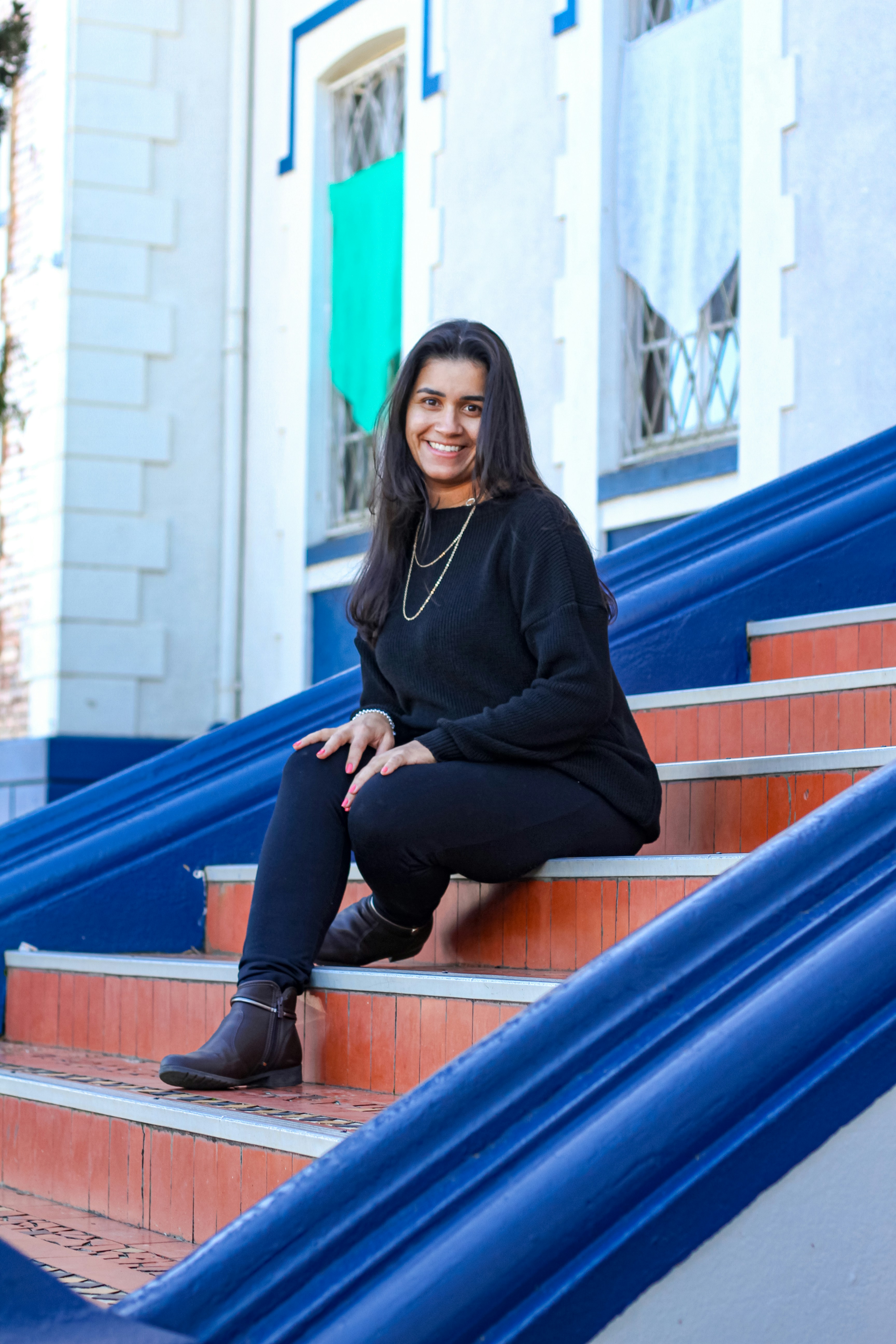A woman sitting on the steps of a building