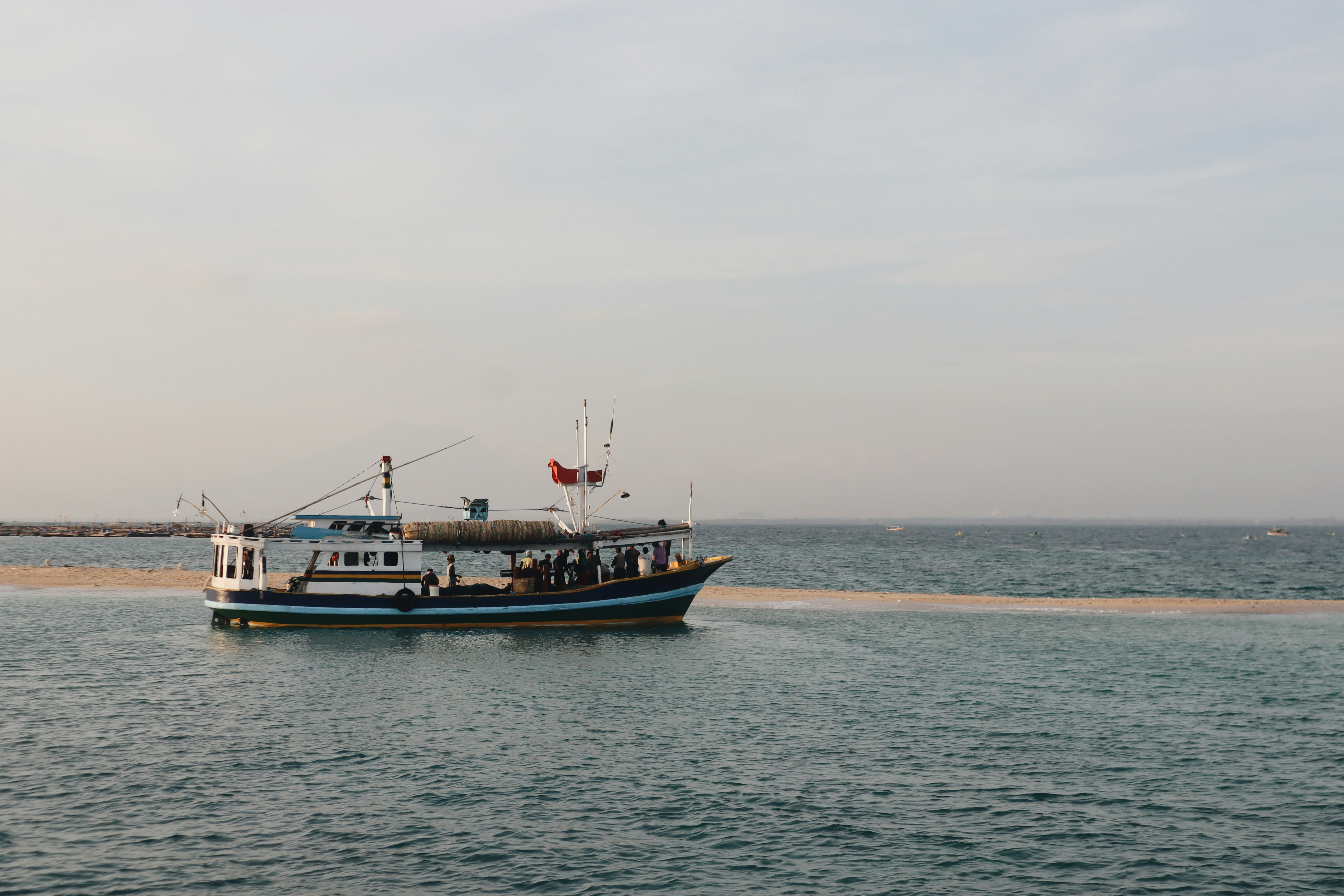 A large boat floating on top of a large body of water