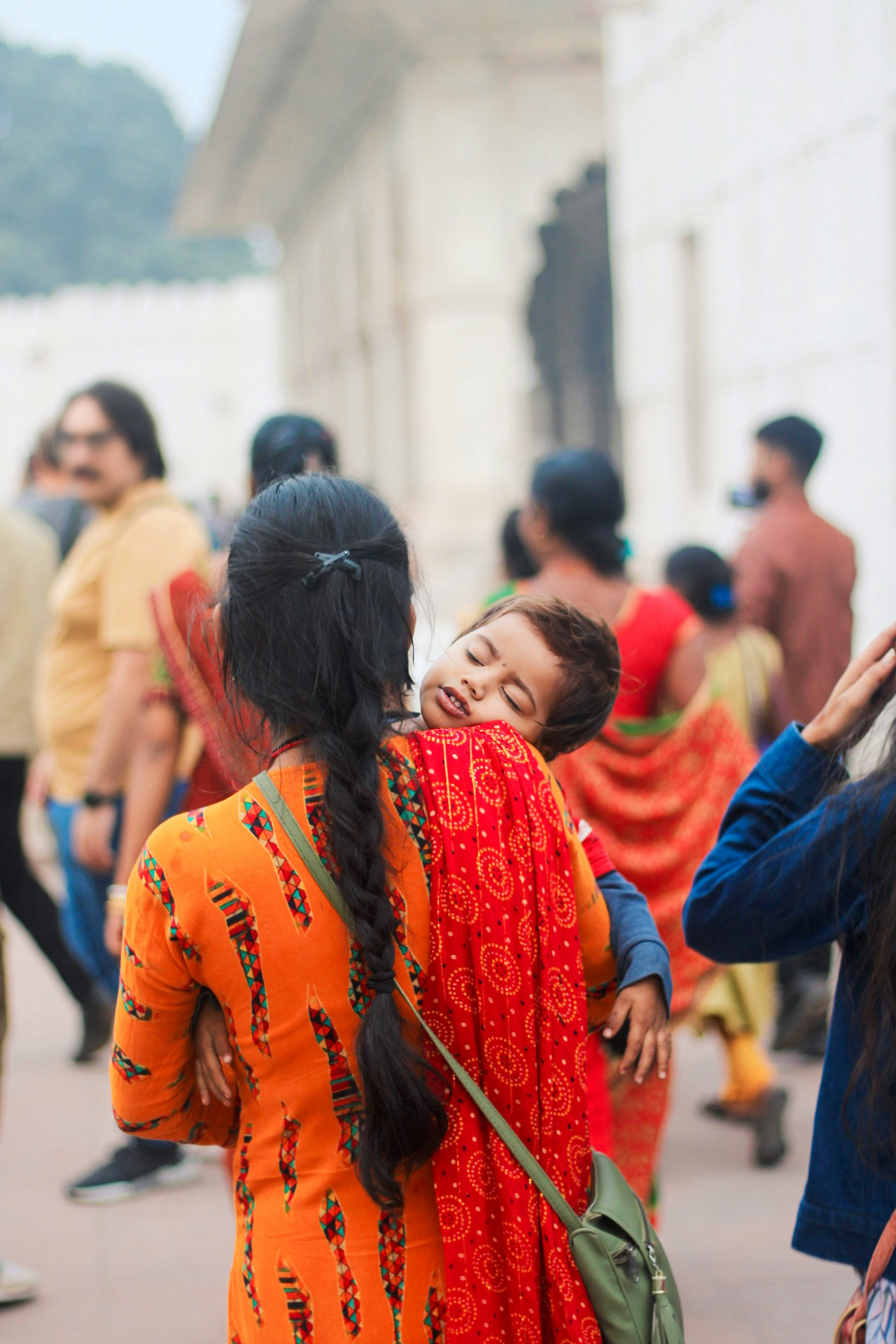 A group of people walking down a street next to each other