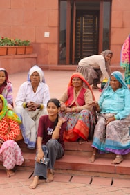 A group of women sitting on the steps of a building