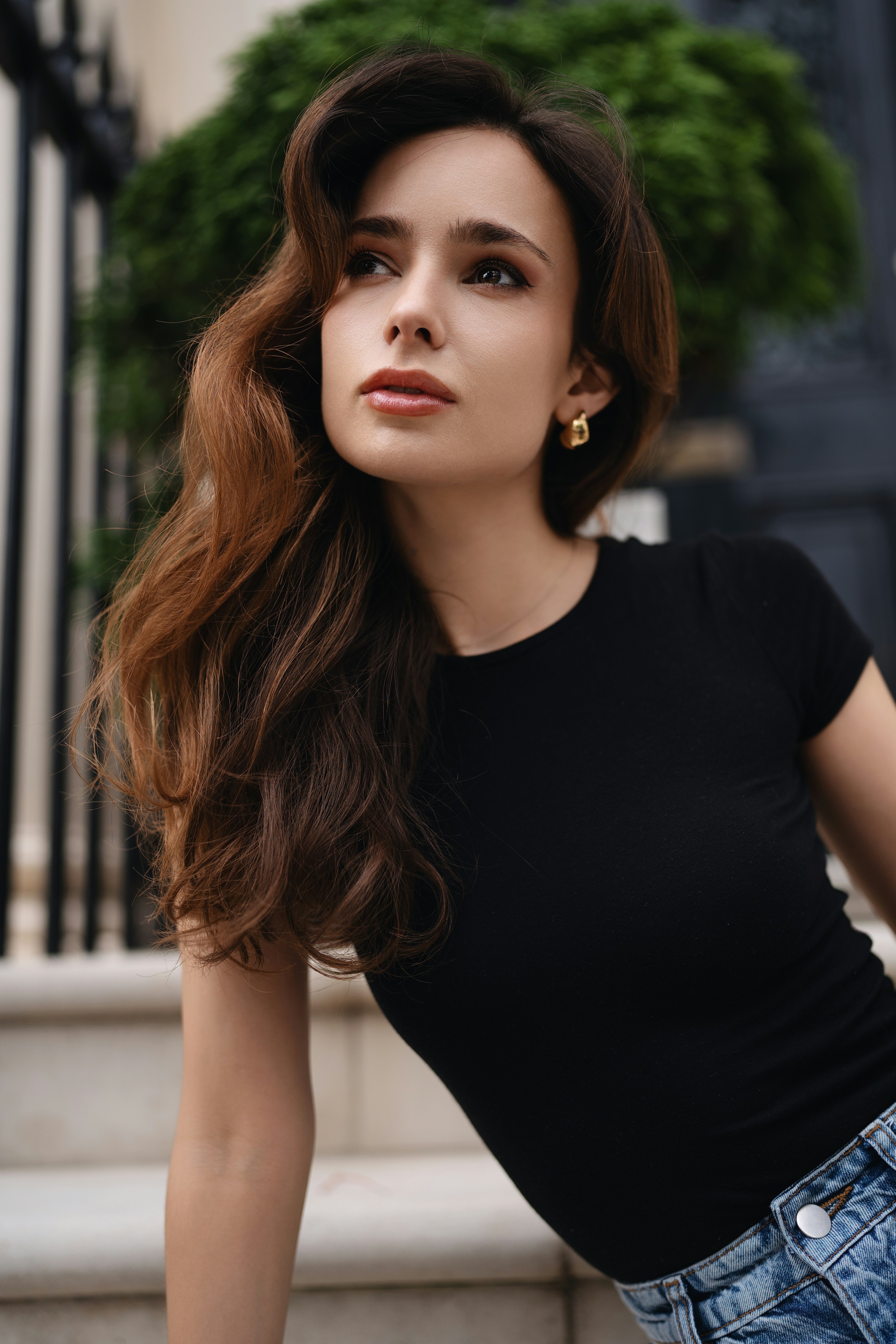 A woman in a black shirt and jean shorts