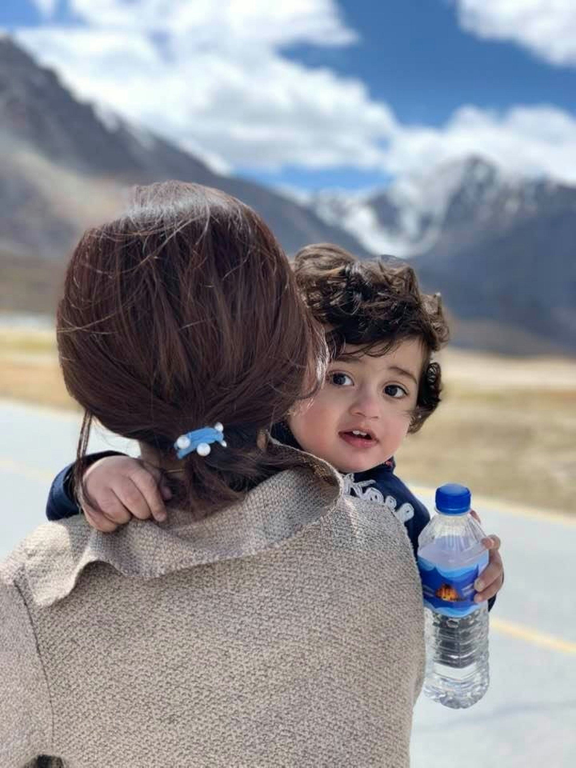 A woman holding a small child in her arms