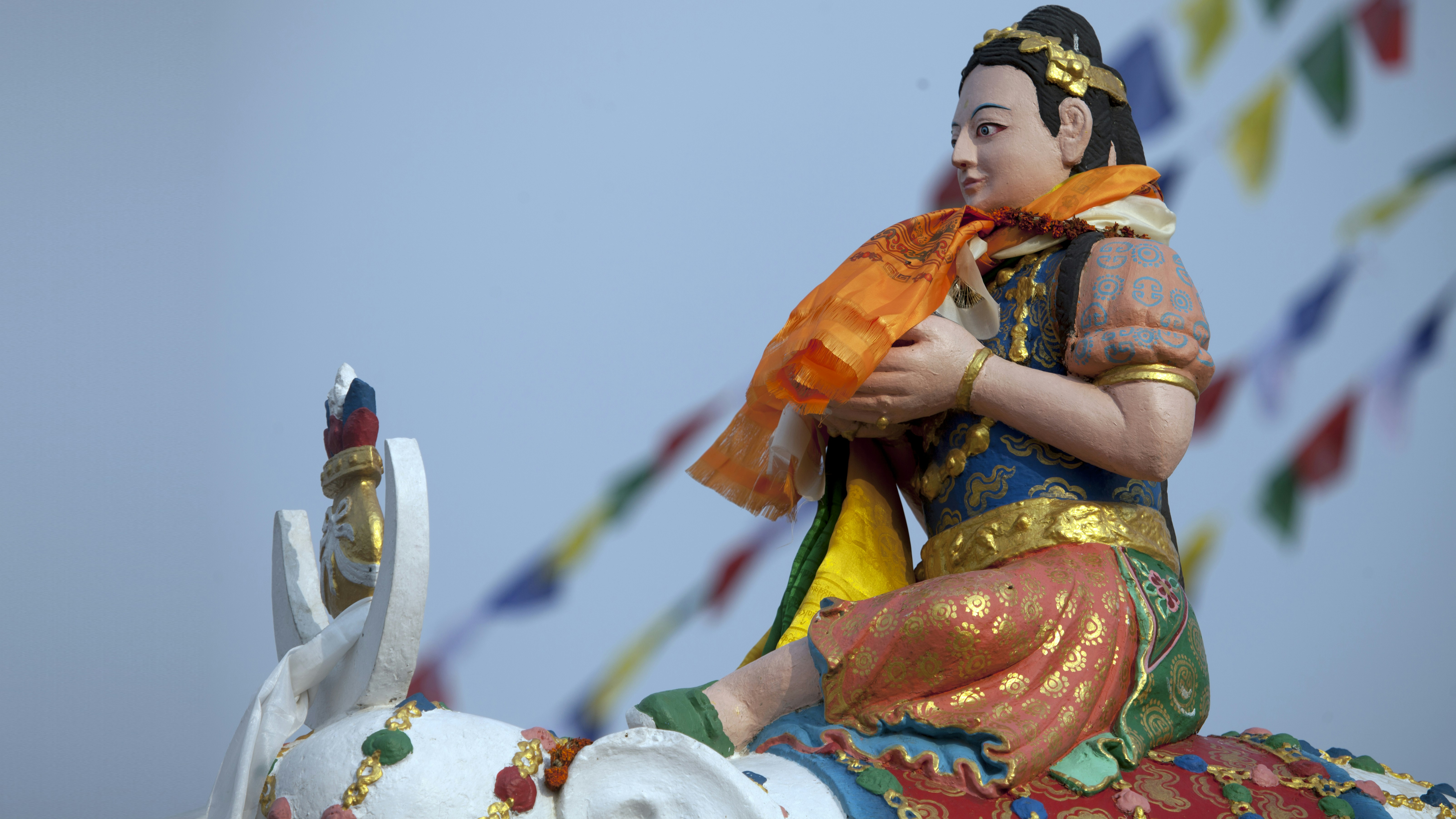 A statue of a woman riding on the back of an elephant