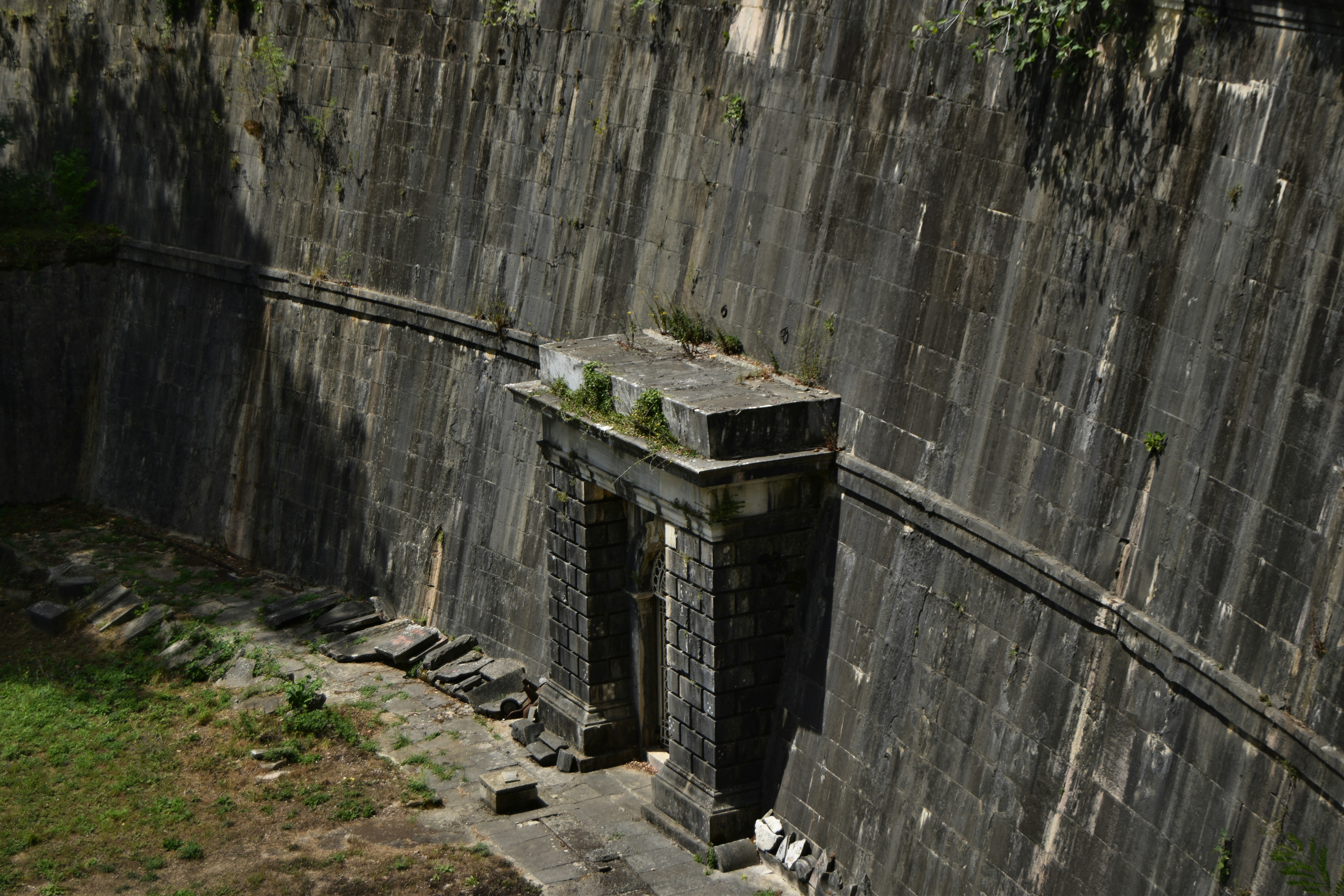 A stone wall with a clock on top of it