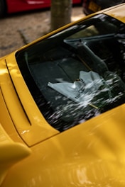 A yellow sports car parked on the side of the road
