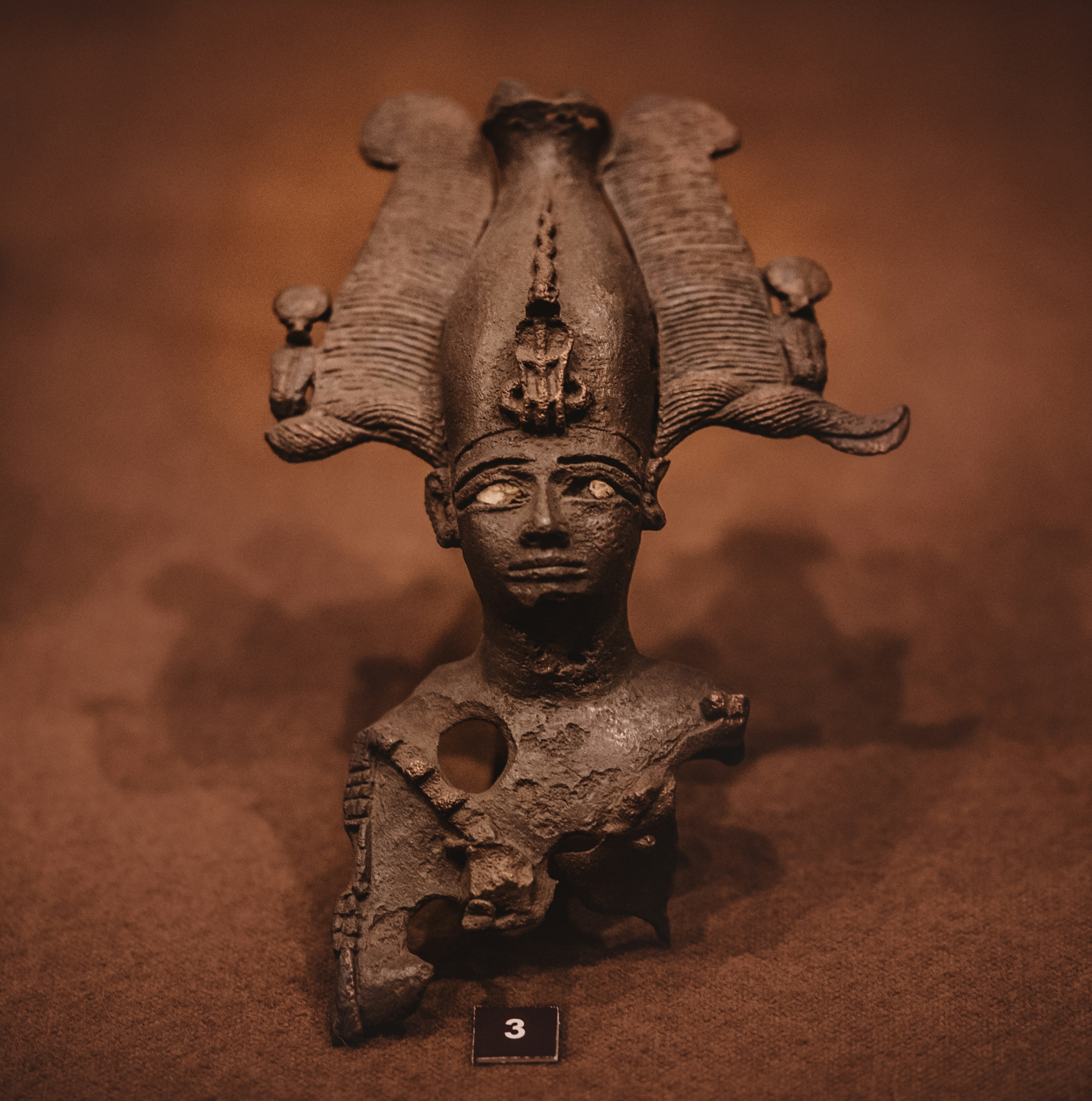 A sculpture of a woman's head on a table