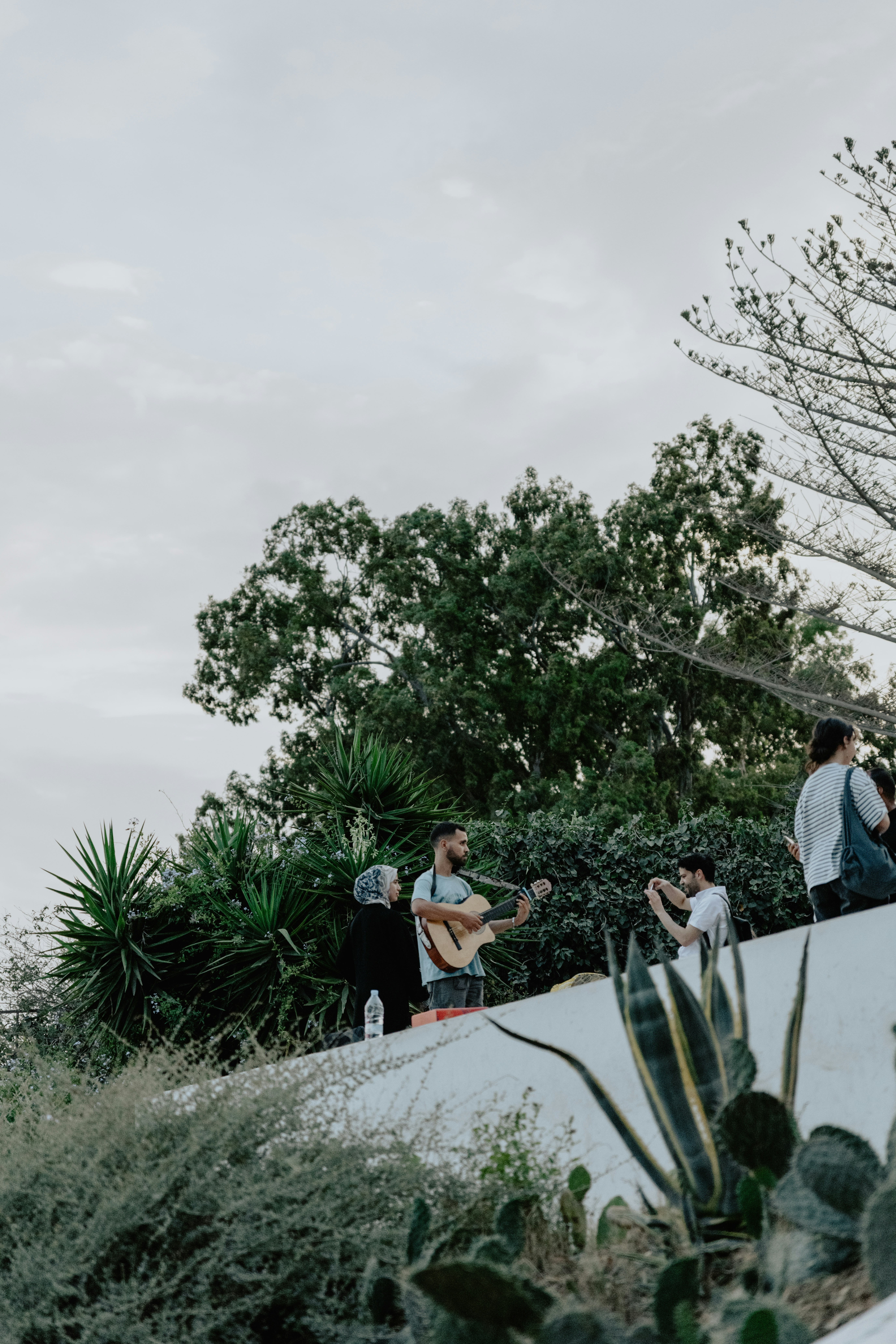 A group of people standing on top of a white wall