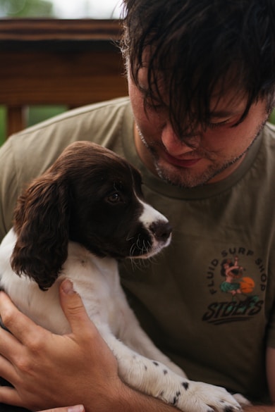 A man holding a puppy in his arms