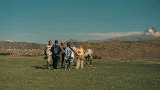 A group of people standing next to each other in a field