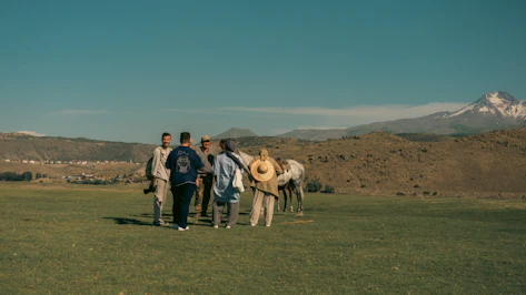 A group of people standing next to each other in a field