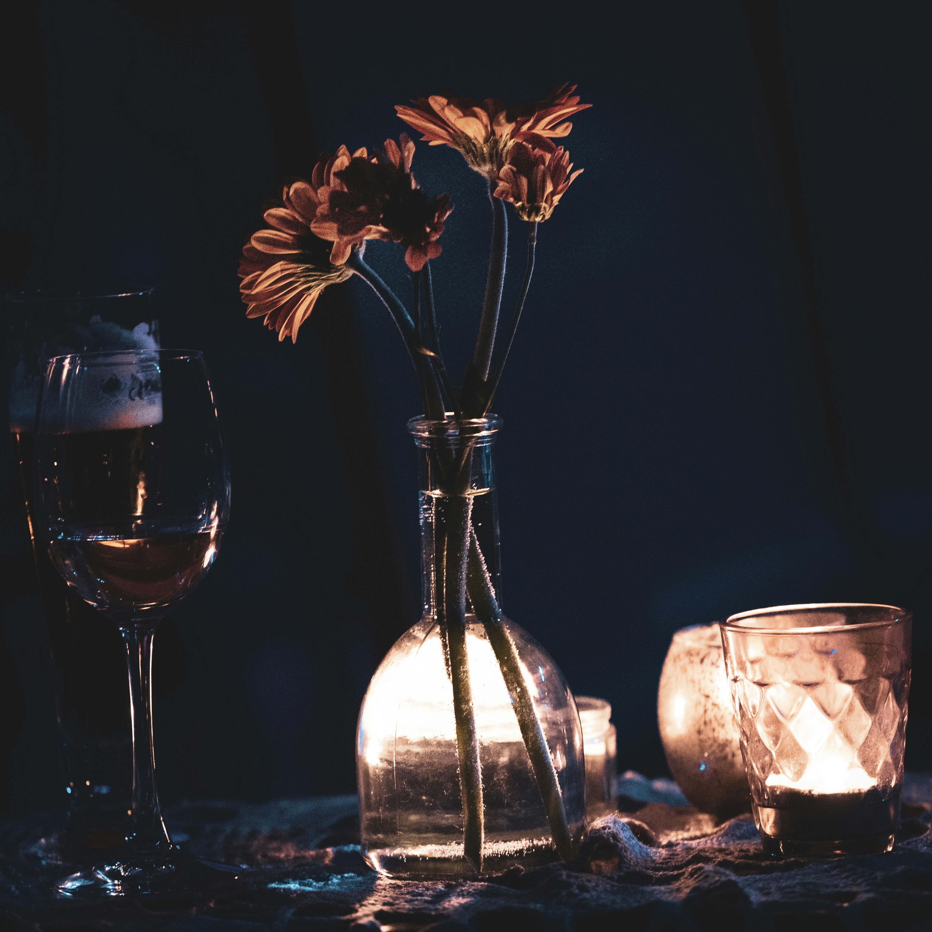 Intimate restaurant table setting with candles and local flowers
