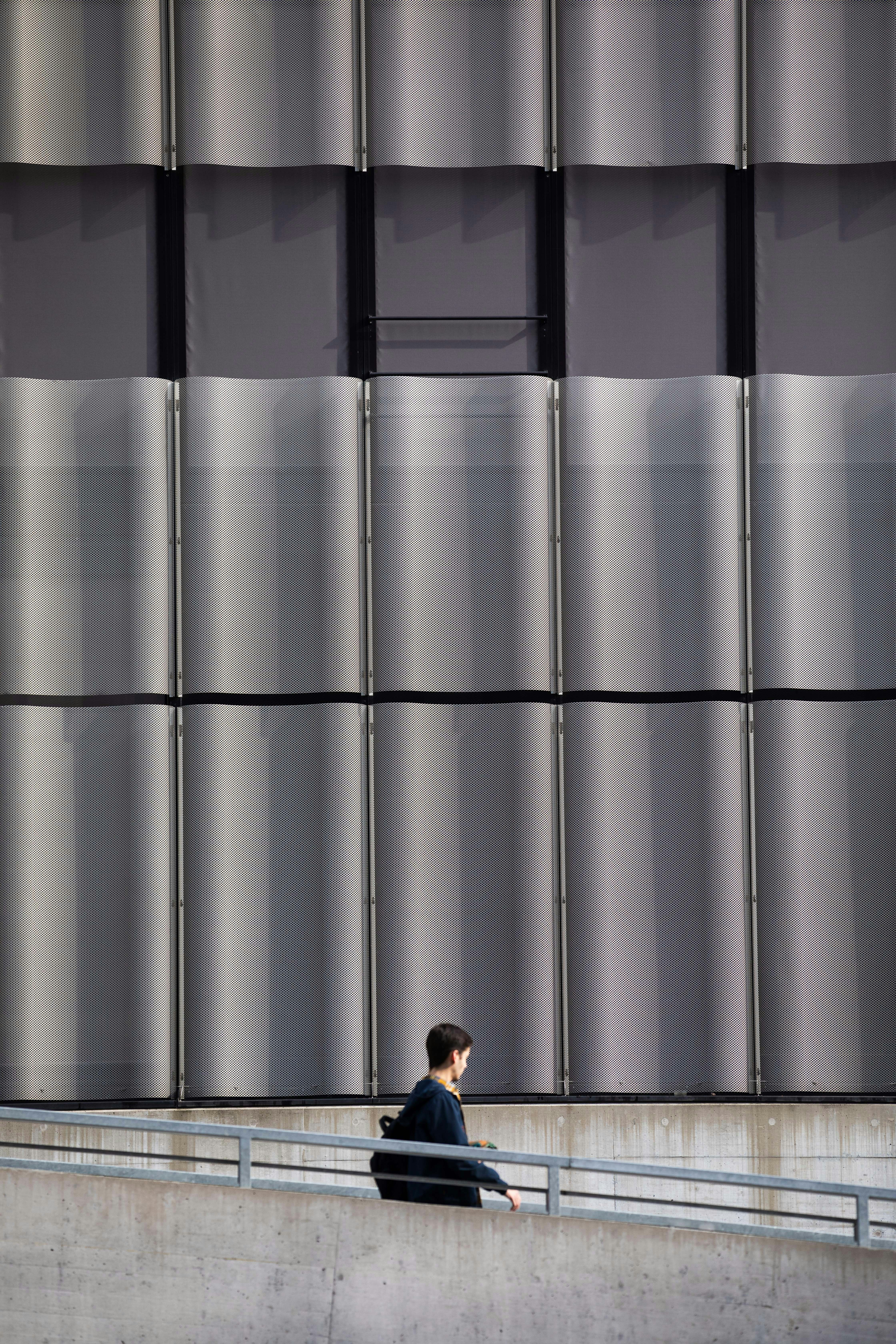 A man sitting on a bench in front of a building