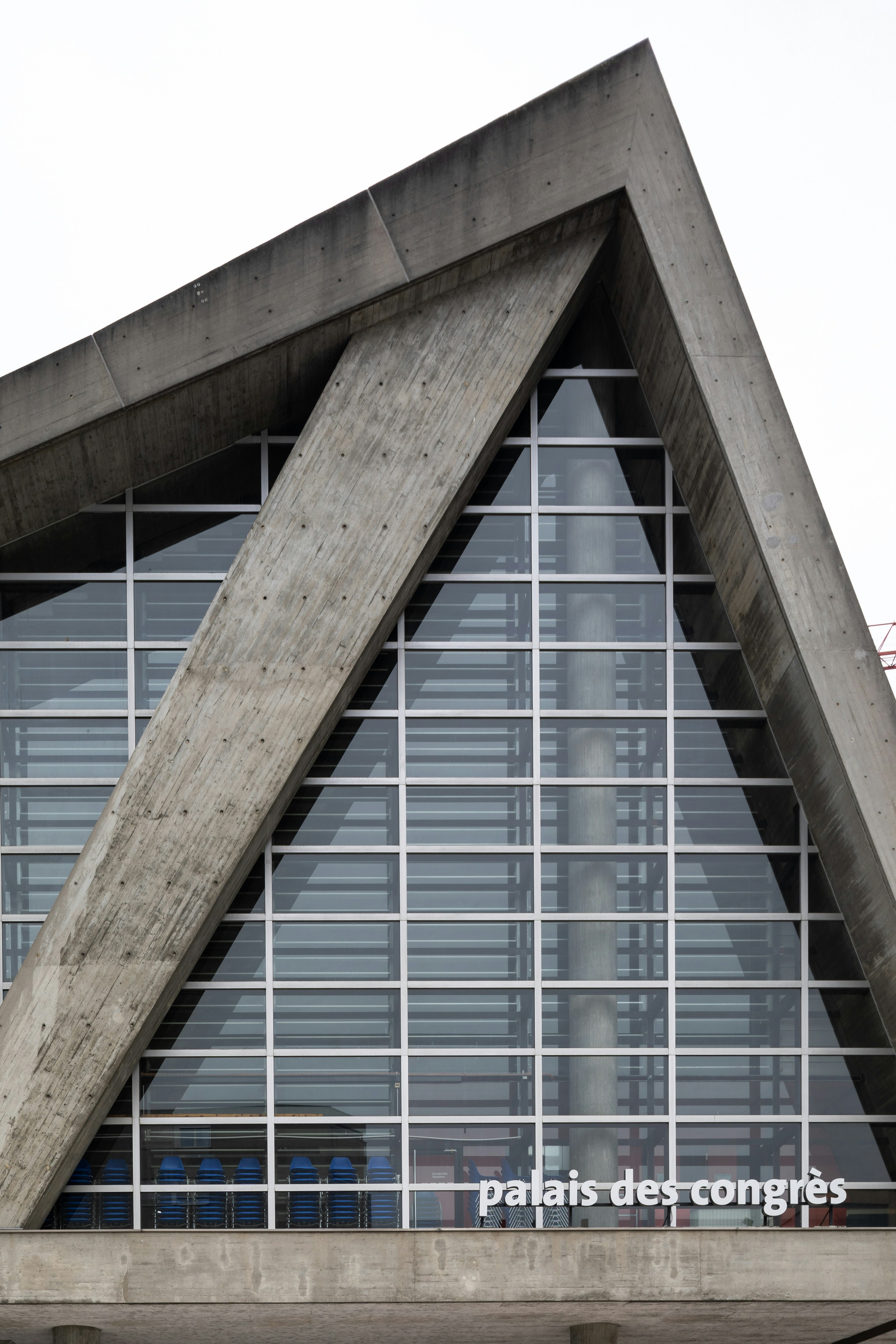 A tall building with a triangular roof and windows