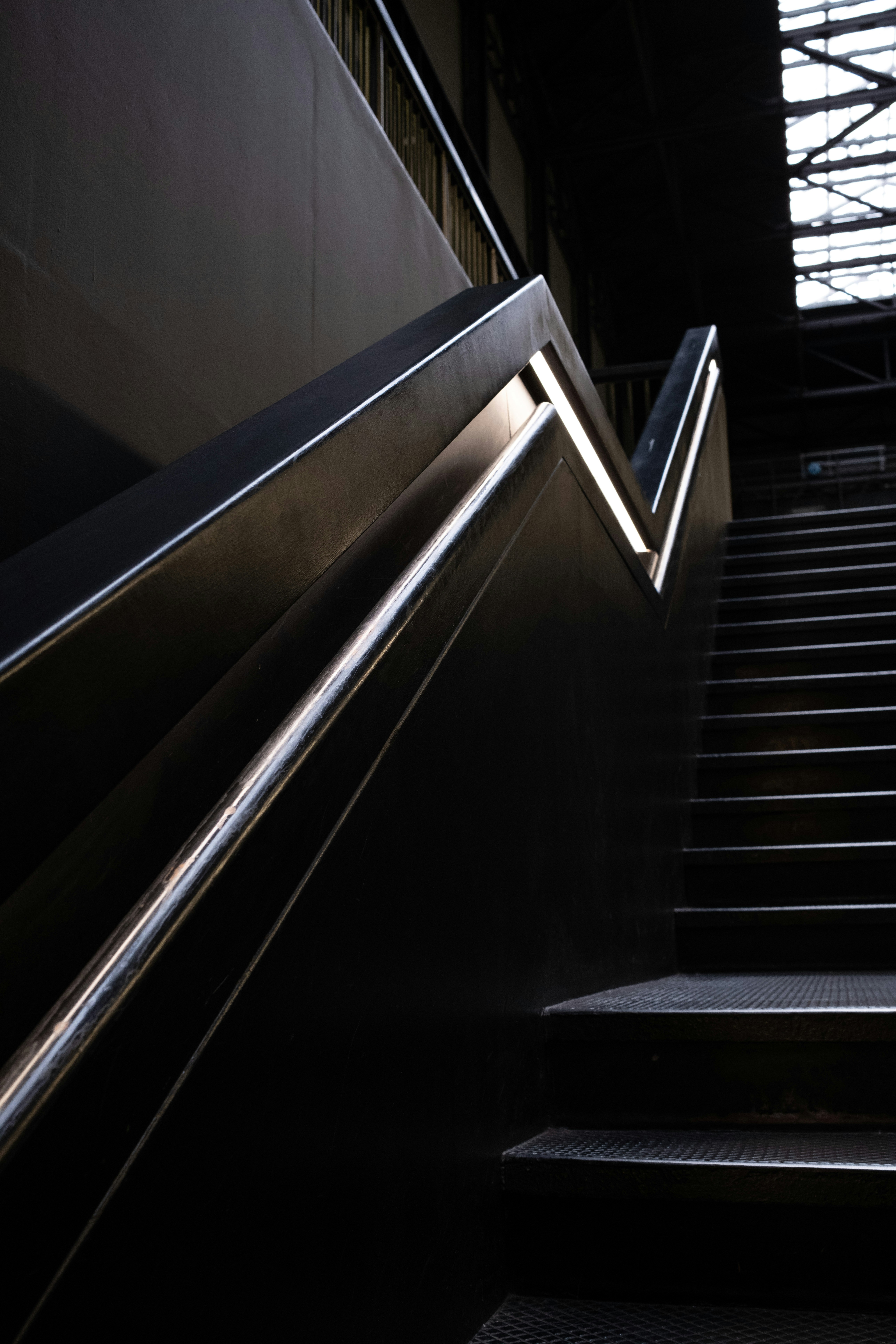 An escalator in a train station with a skylight