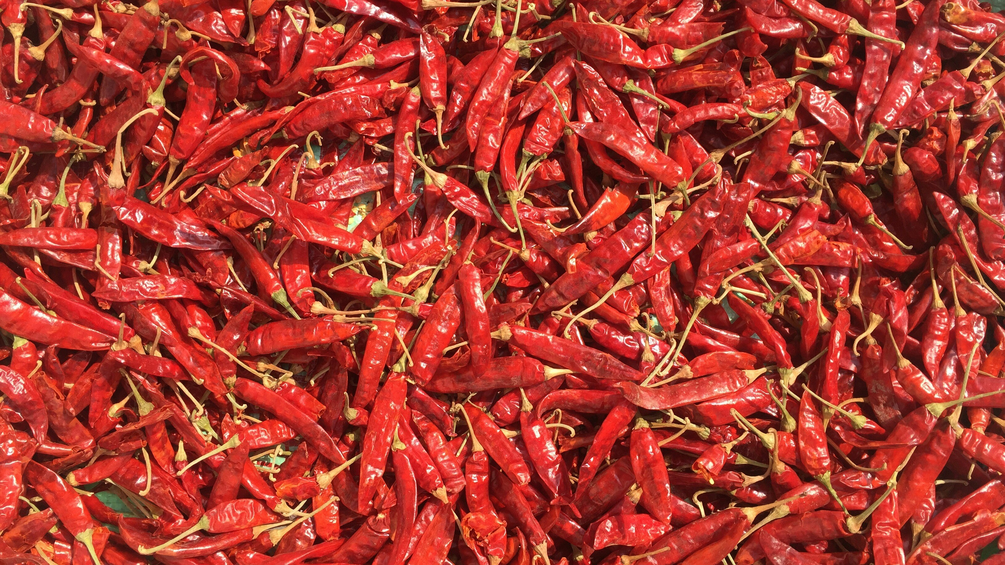 A pile of red peppers sitting on top of a table