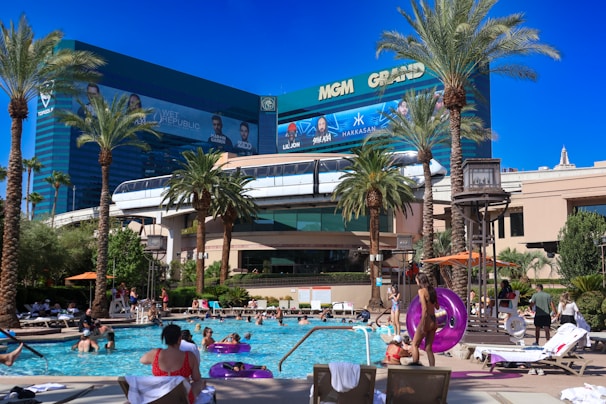 A group of people sitting around a swimming pool
