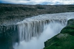 A large waterfall with water cascading over it