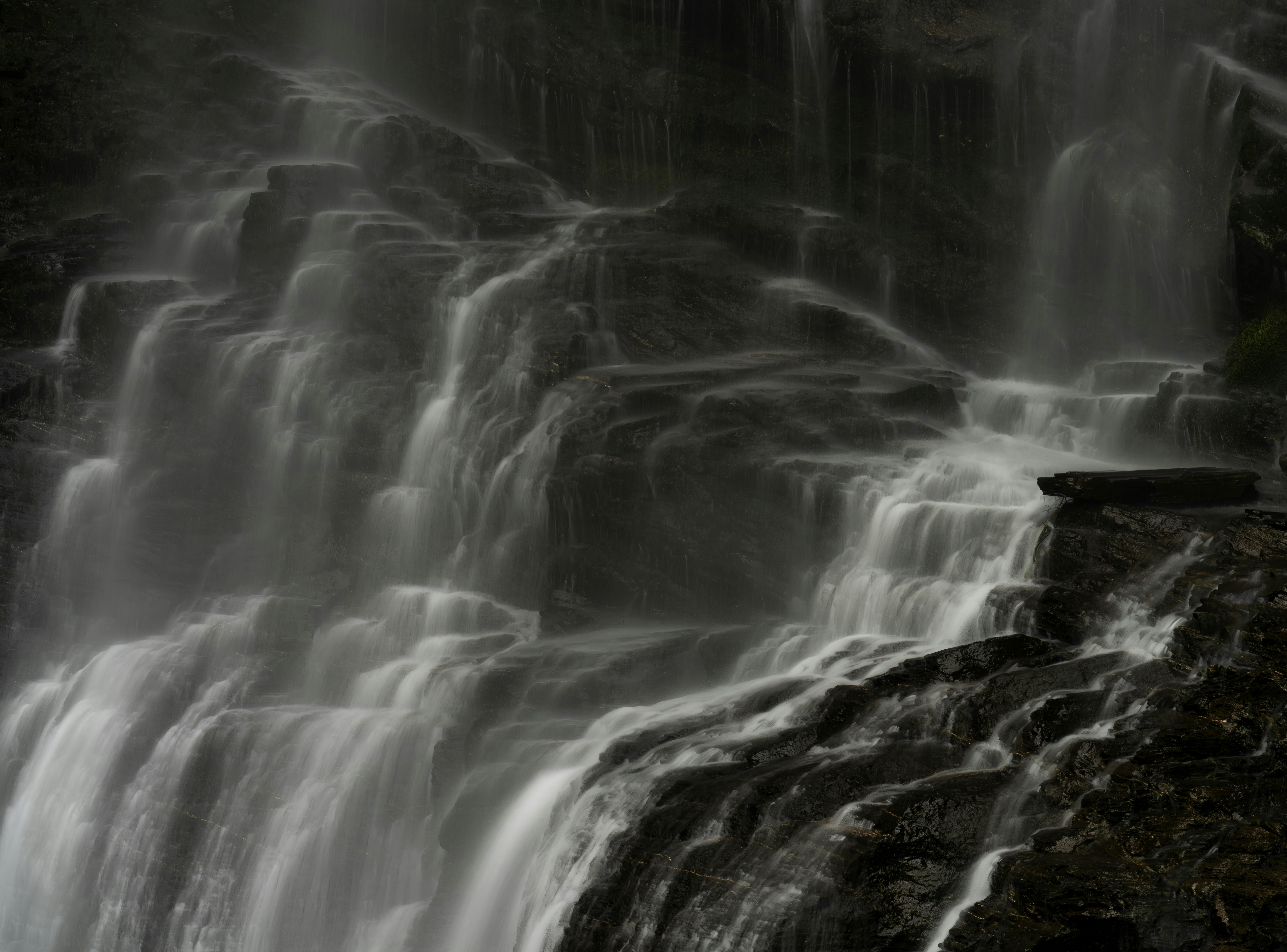 A man standing in front of a waterfall