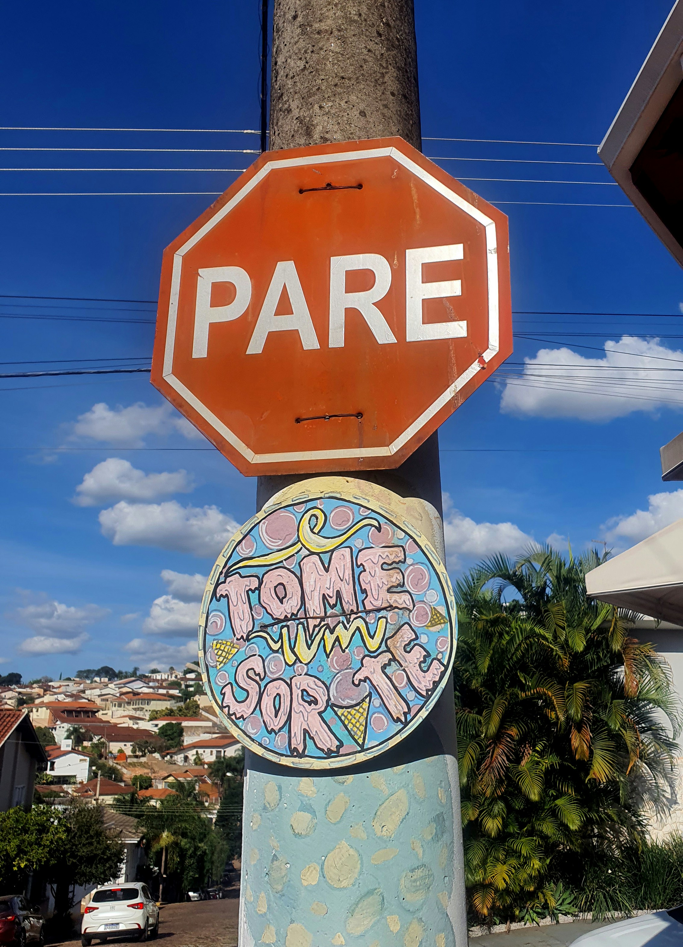 A stop sign that has some stickers on it