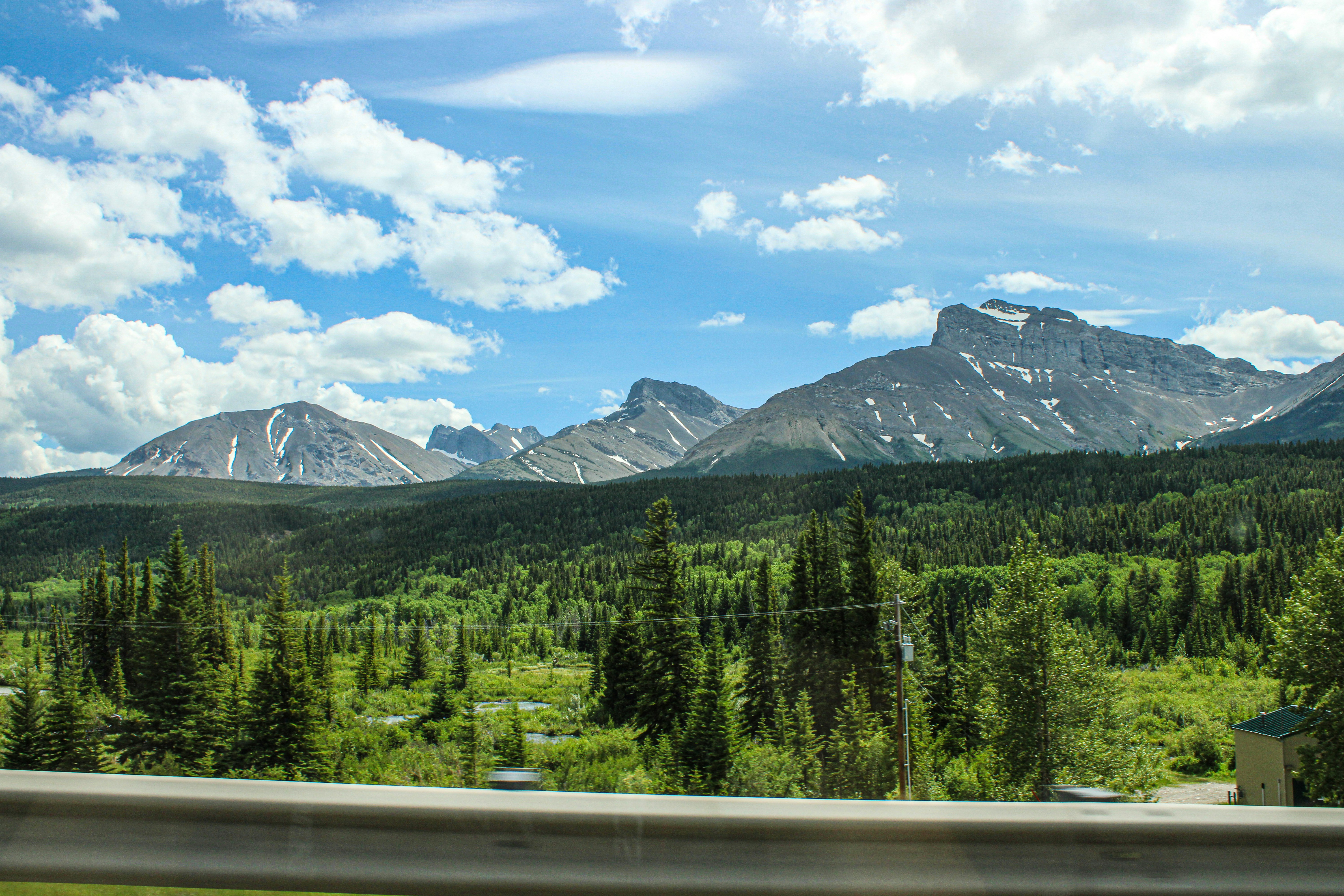 A view of a mountain range from a moving car