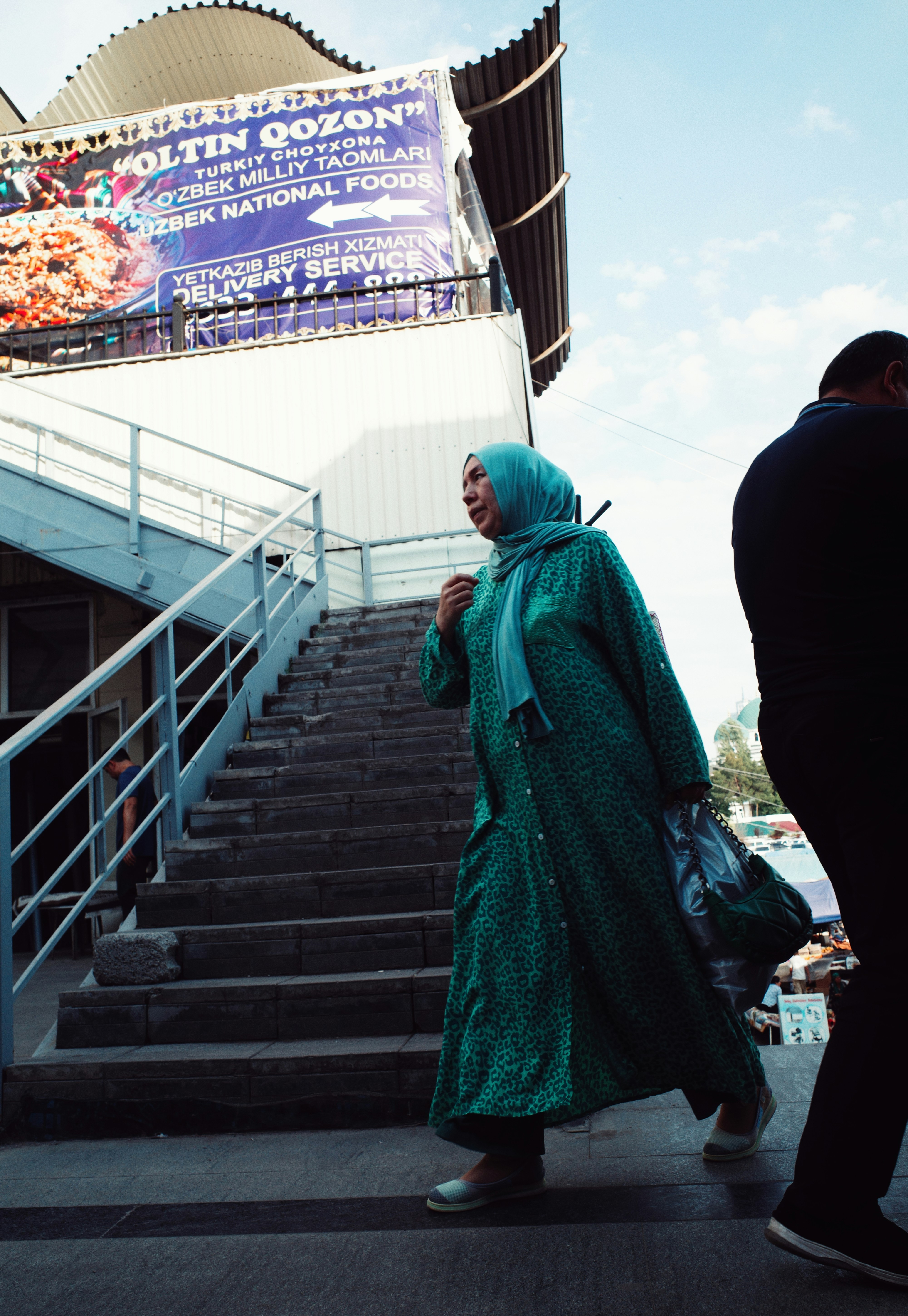 A man and a woman walking down a flight of stairs