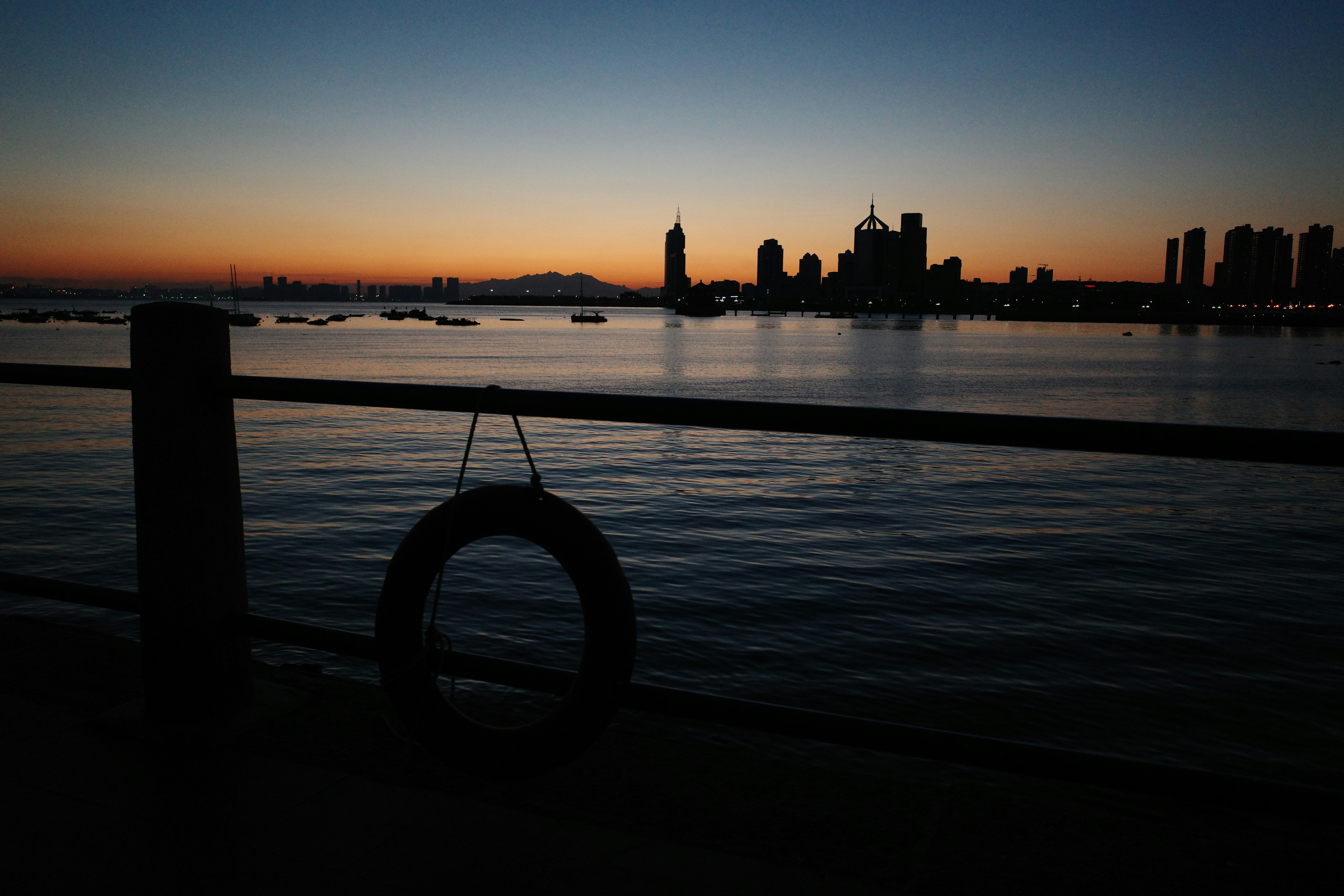 A view of a body of water with a city in the background