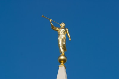A golden statue on top of a building