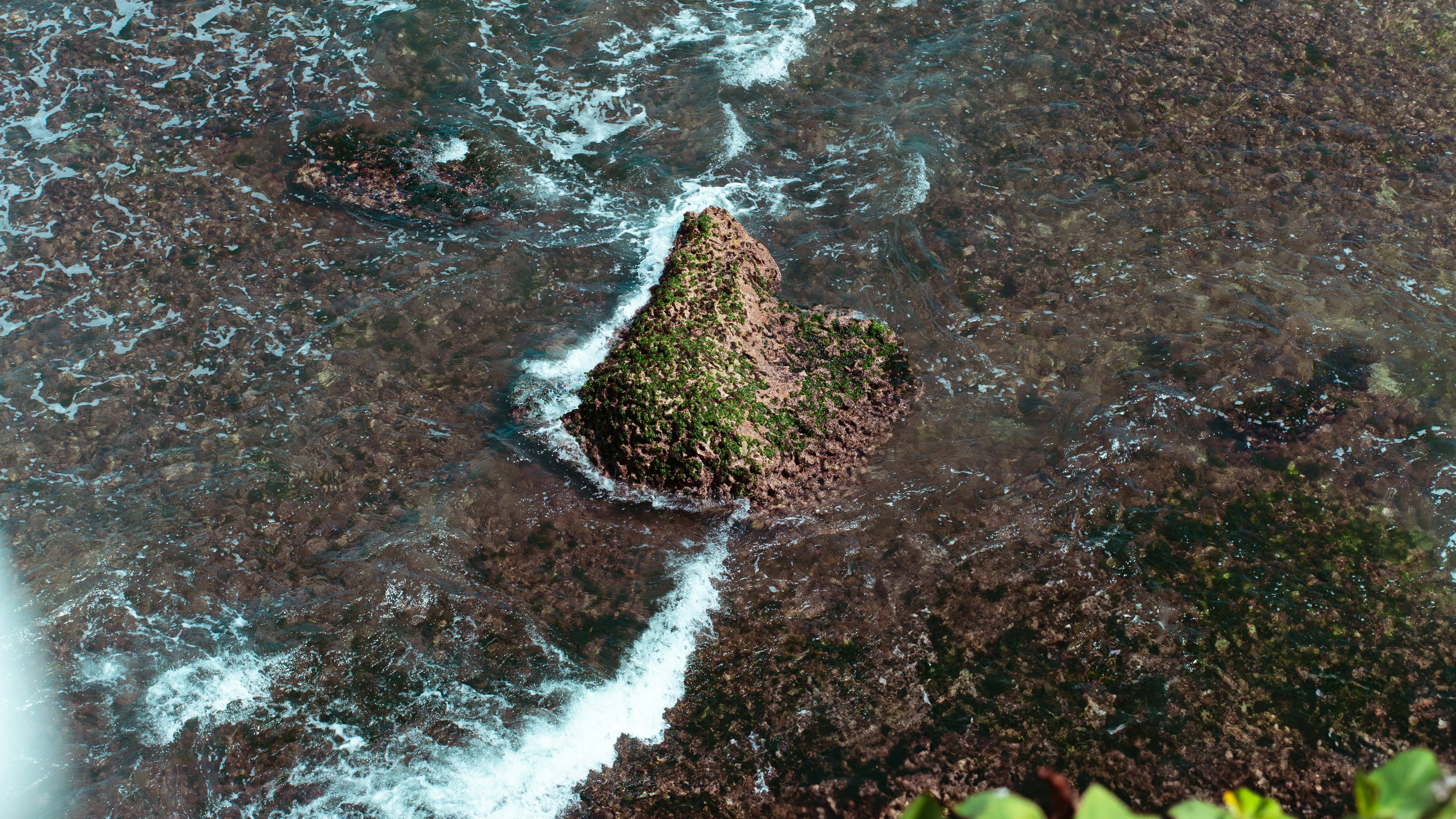 An aerial view of the ocean and rocks