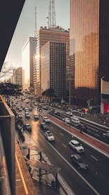 A city street filled with lots of traffic next to tall buildings