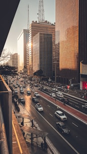 A city street filled with lots of traffic next to tall buildings