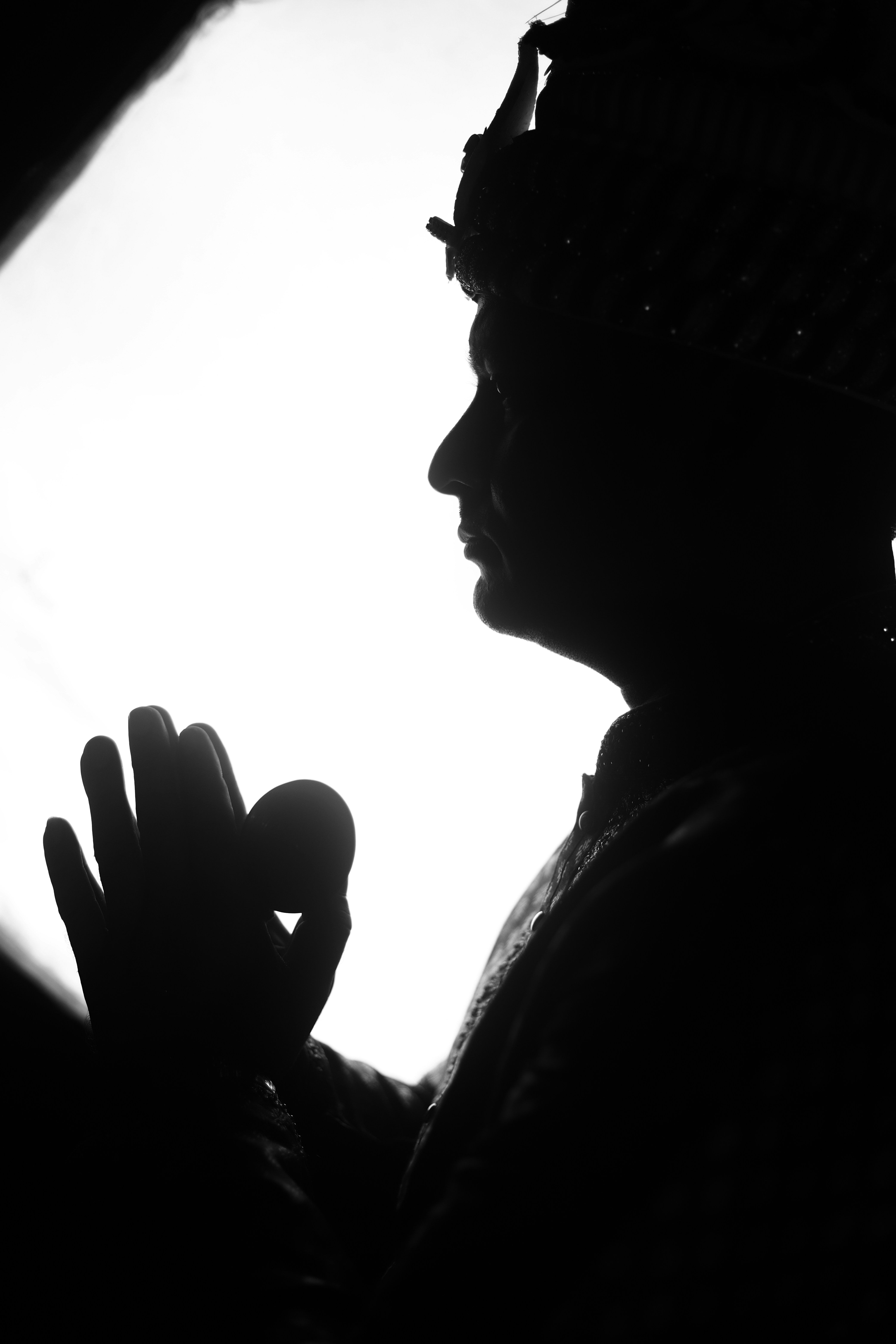 A silhouette of a person holding a cell phone