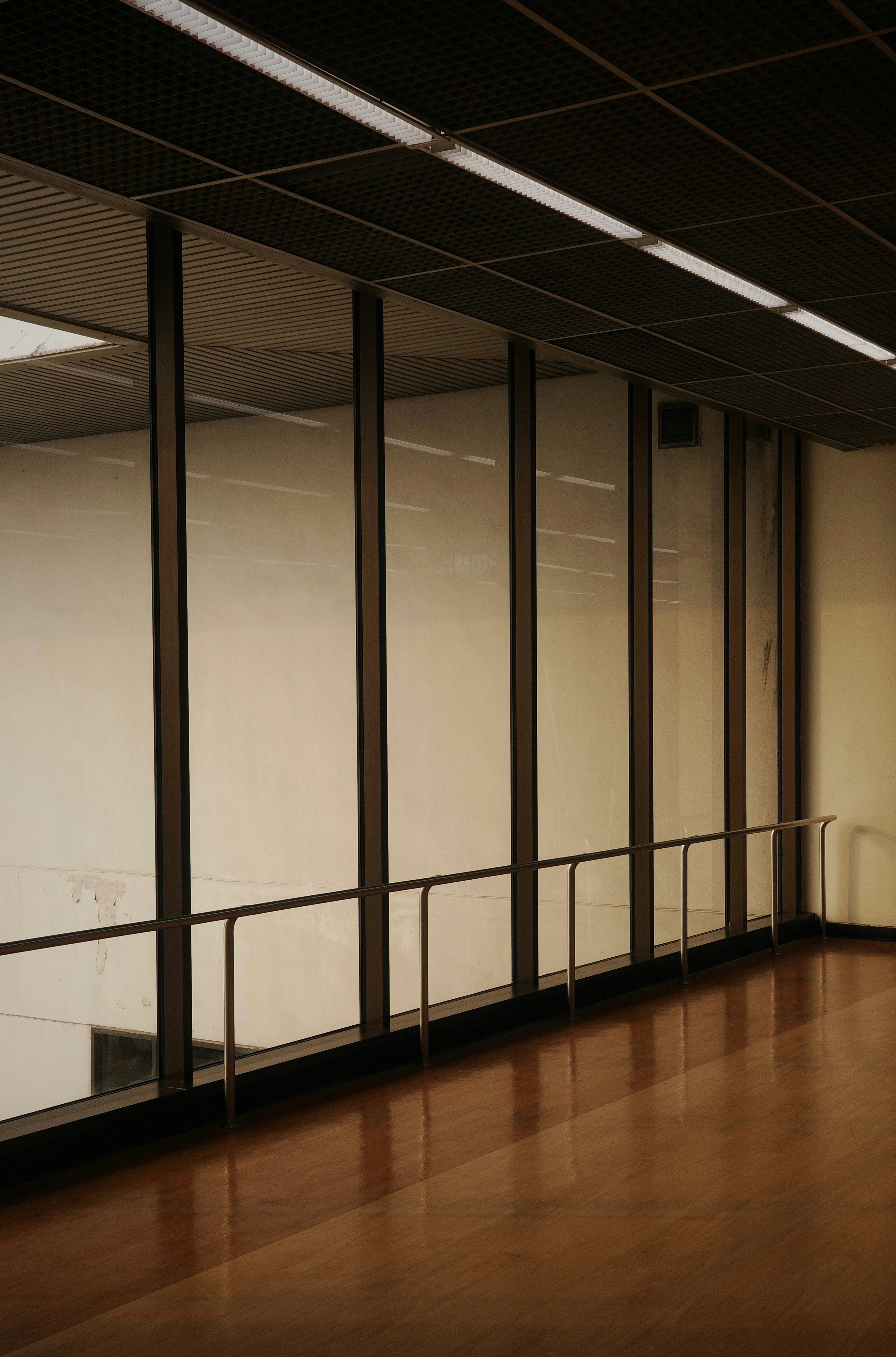 A room with a wooden floor and glass walls