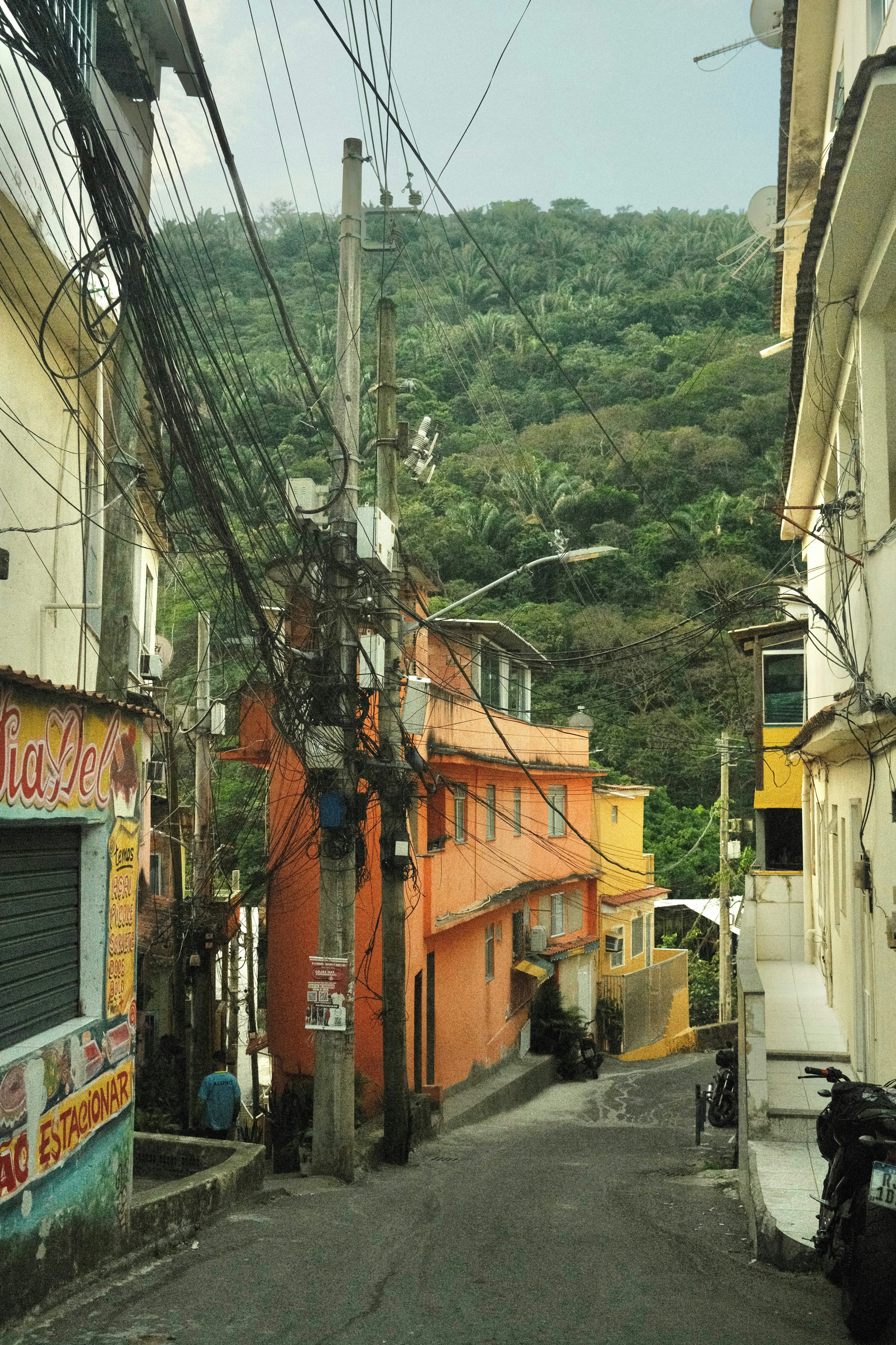 A narrow street with a mountain in the background