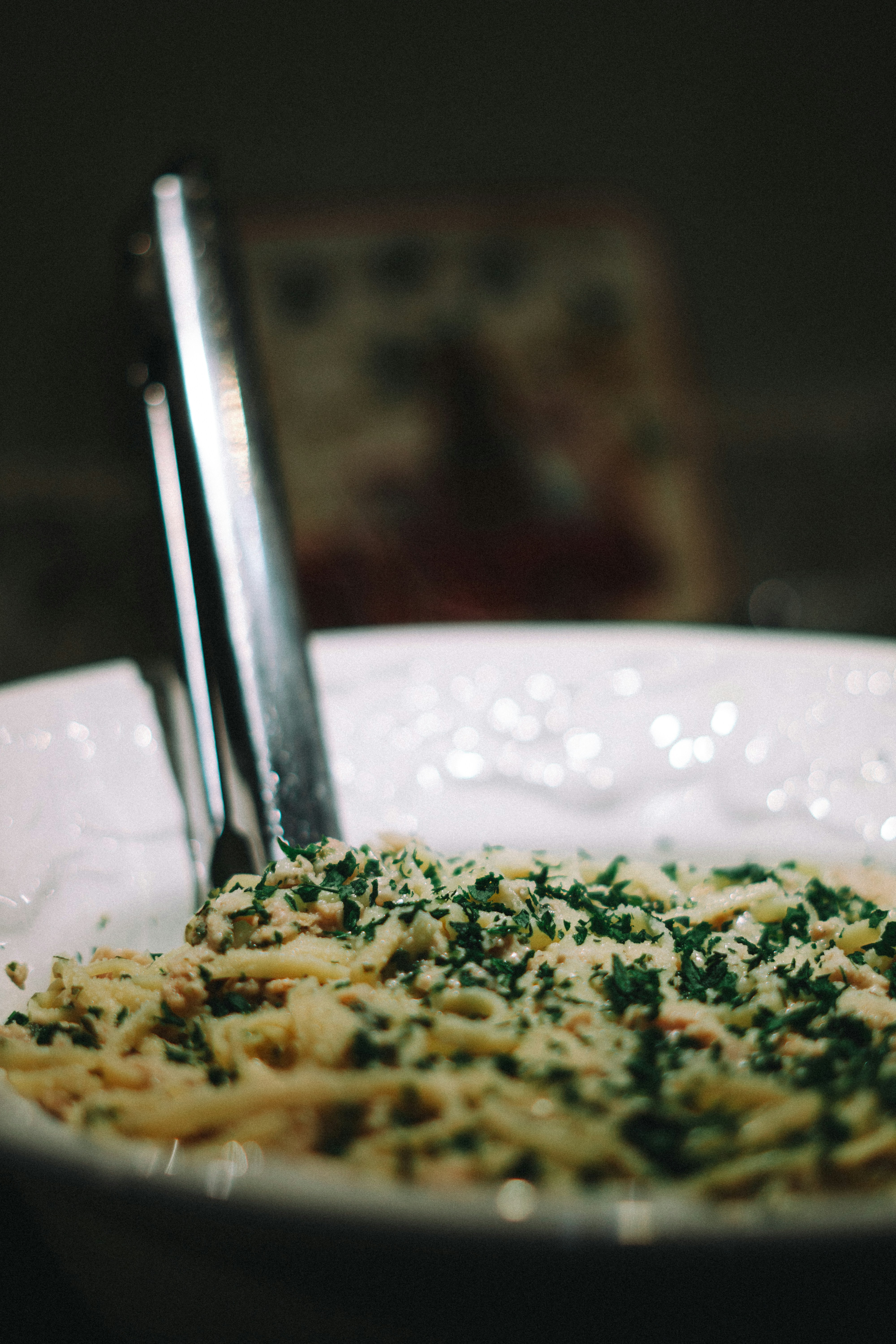 A bowl of pasta with spinach and parmesan cheese