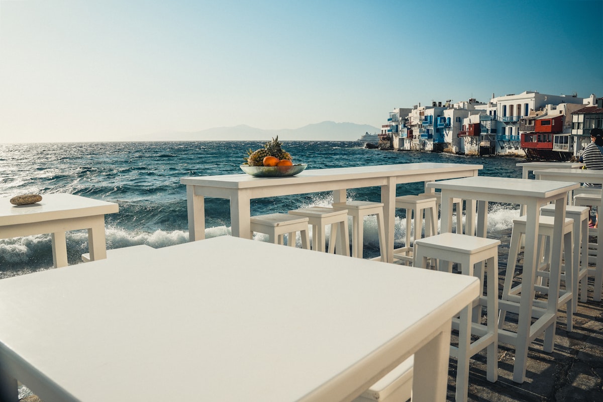 Mykonos Super Paradise — white beach furniture on a Cycladic beach overlooking the Aegean Sea